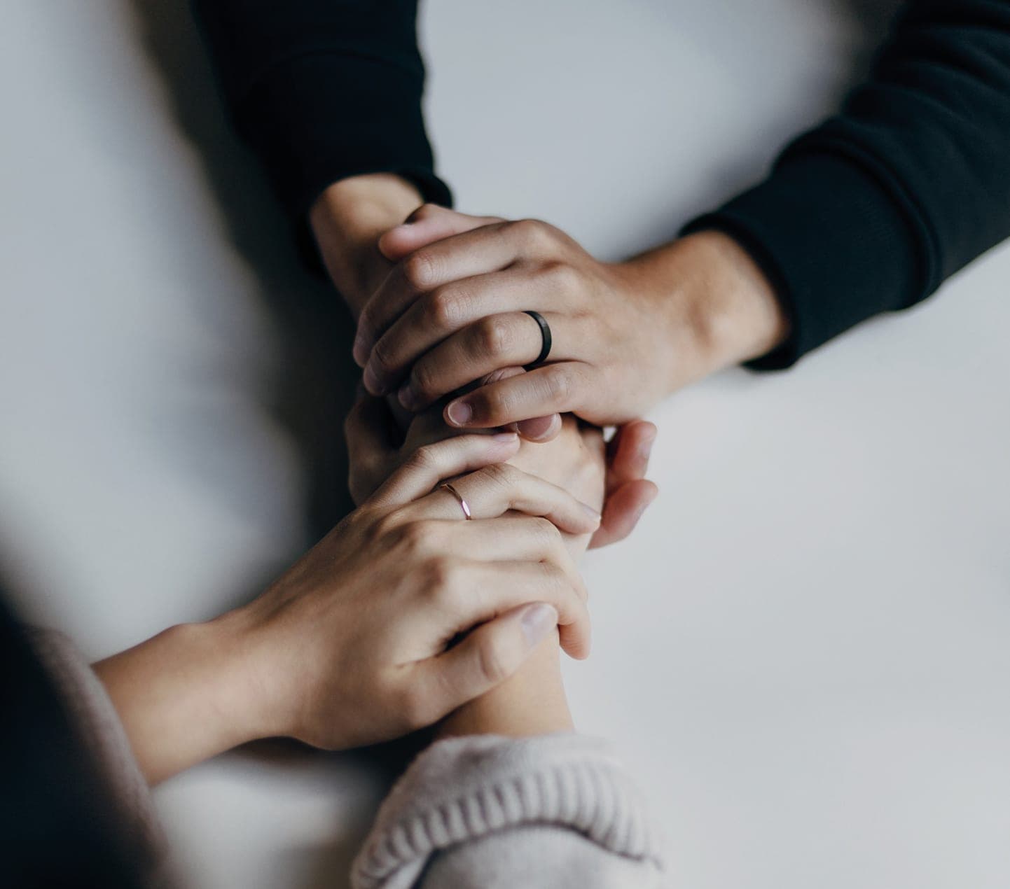 Two people clasping hands in support